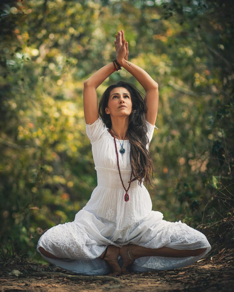 pexels-photo-2035066-2035066 A woman meditating outdoors in a forest setting, embracing tranquility.