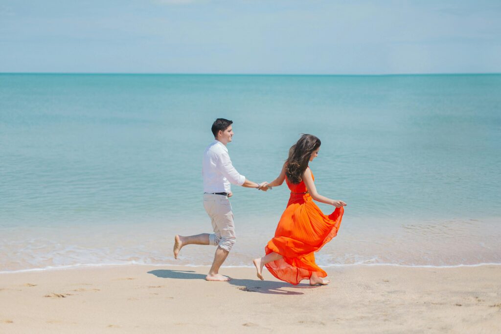 pexels-photo-792726-792726 A joyful couple runs barefoot along Baku's sunny coastline, embodying carefree summer love.